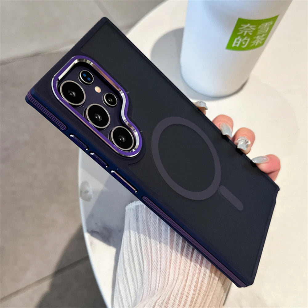 A person holding a Samsung Galaxy smartphone in a luxury matte magnetic black case with orange accents around the camera and edges.