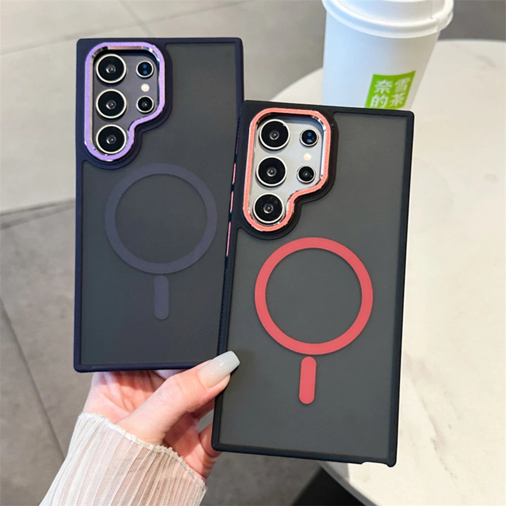 A person holding a Samsung Galaxy smartphone in a luxury matte magnetic black case with orange accents around the camera and edges.