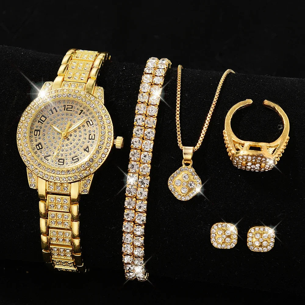 A set of gold-colored jewelry including a watch, bracelet, necklace, and earrings, all adorned with faux diamonds.