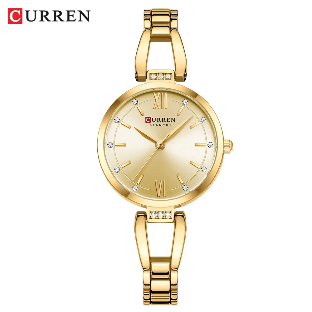 A gold-colored CURREN quartz wristwatch with a stainless steel band and rhinestone embellishments, displayed on a cream background.