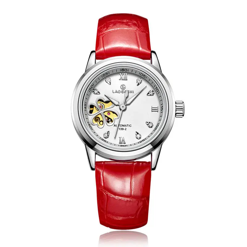 A red leather band mechanical wristwatch with a silver alloy case, featuring a white dial with diamond accents and a four-leaf clover design in the center.