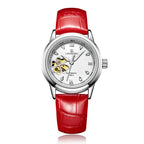 A red leather band mechanical wristwatch with a silver alloy case, featuring a white dial with diamond accents and a four-leaf clover design in the center.